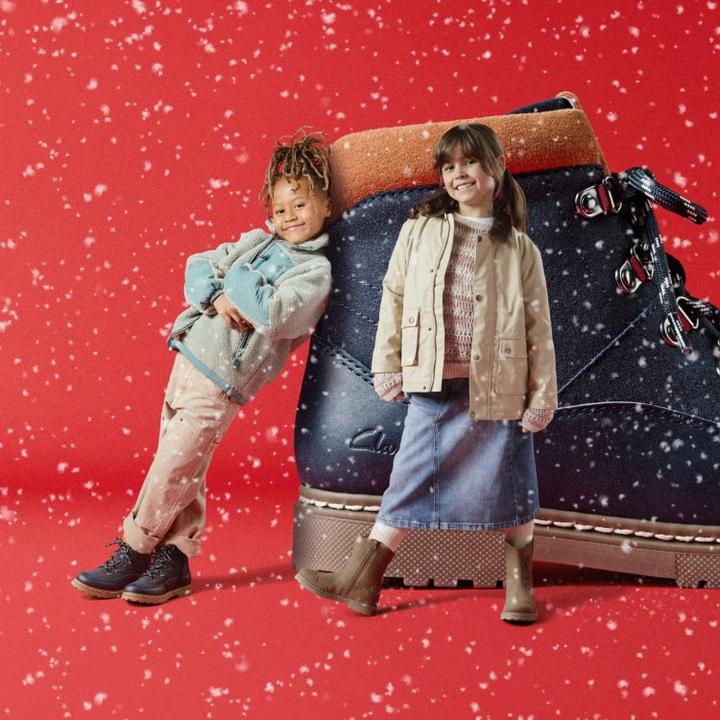 girl and boy standing next to kids boots